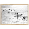 a black and white photo of people surfing in the ocean