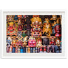 a group of colorful masks on display in a white frame