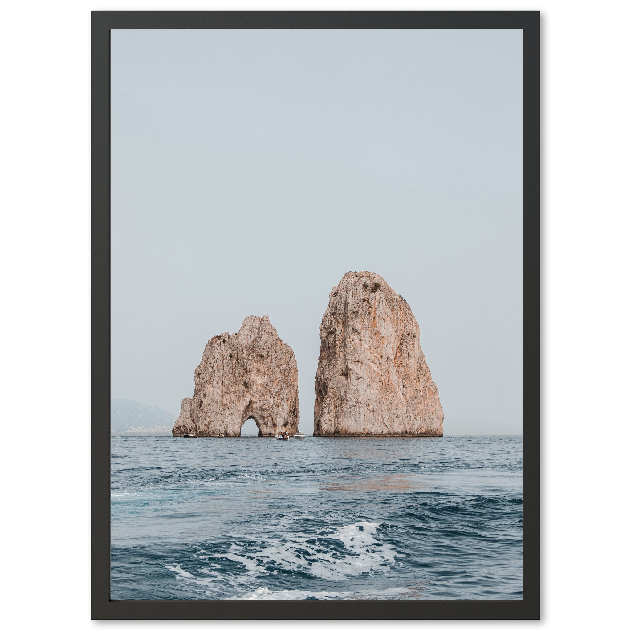 a picture of two large rocks in the ocean