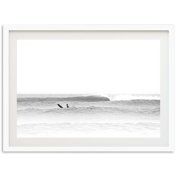 a black and white photo of a surfer in the ocean