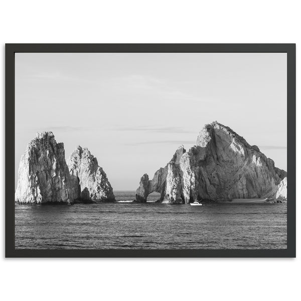 a black and white photo of rocks in the ocean