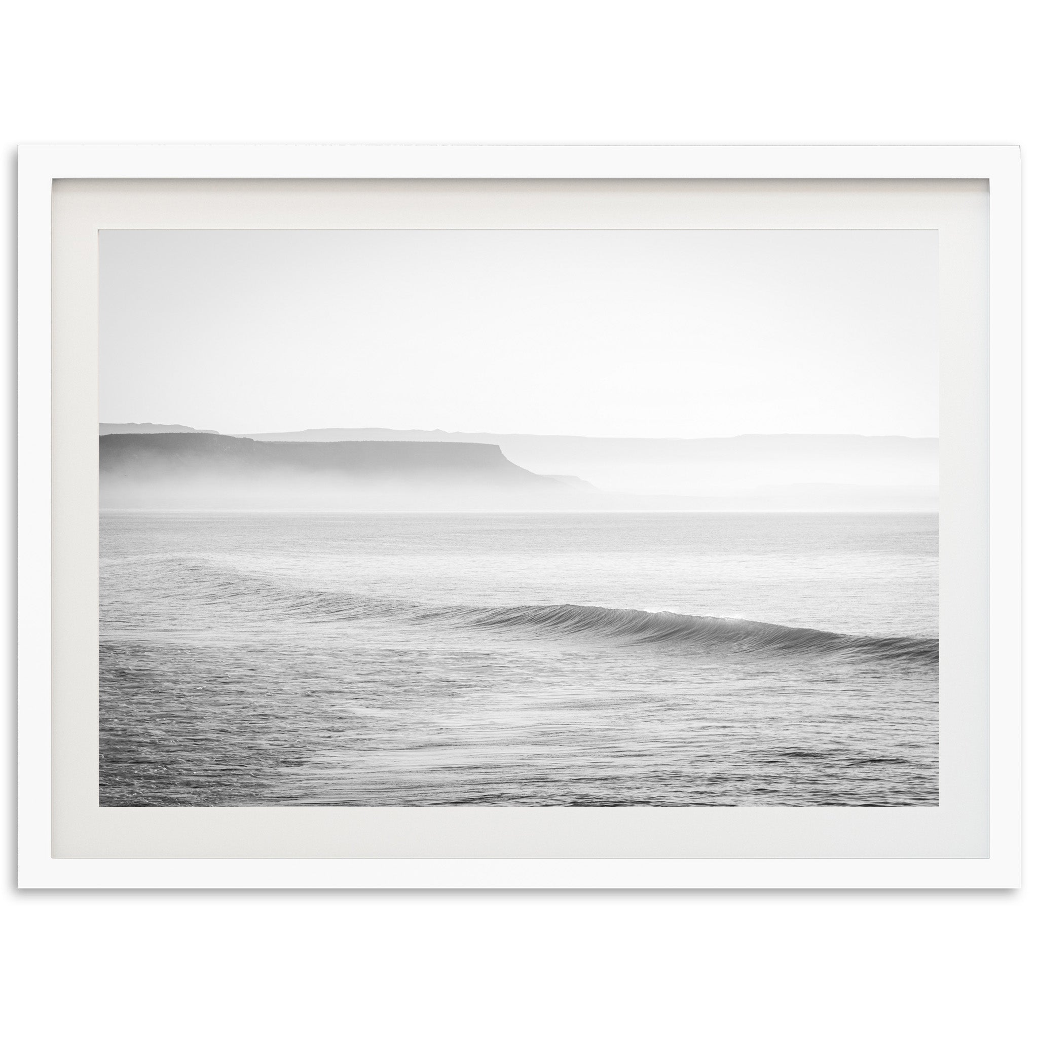 a black and white photo of a wave in the ocean