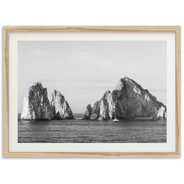 a black and white photo of rocks in the ocean