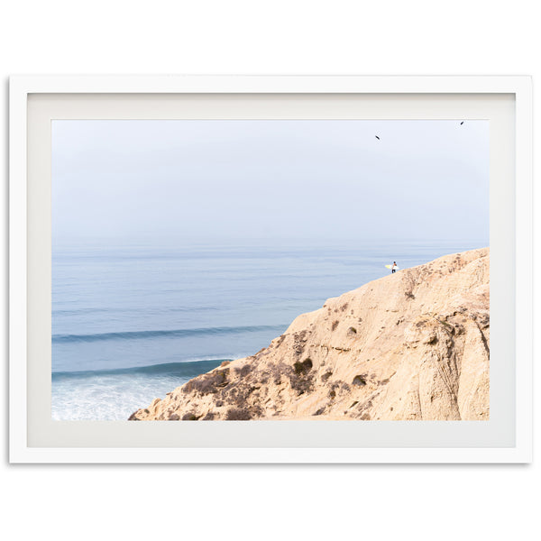 a picture of a person standing on a cliff overlooking the ocean