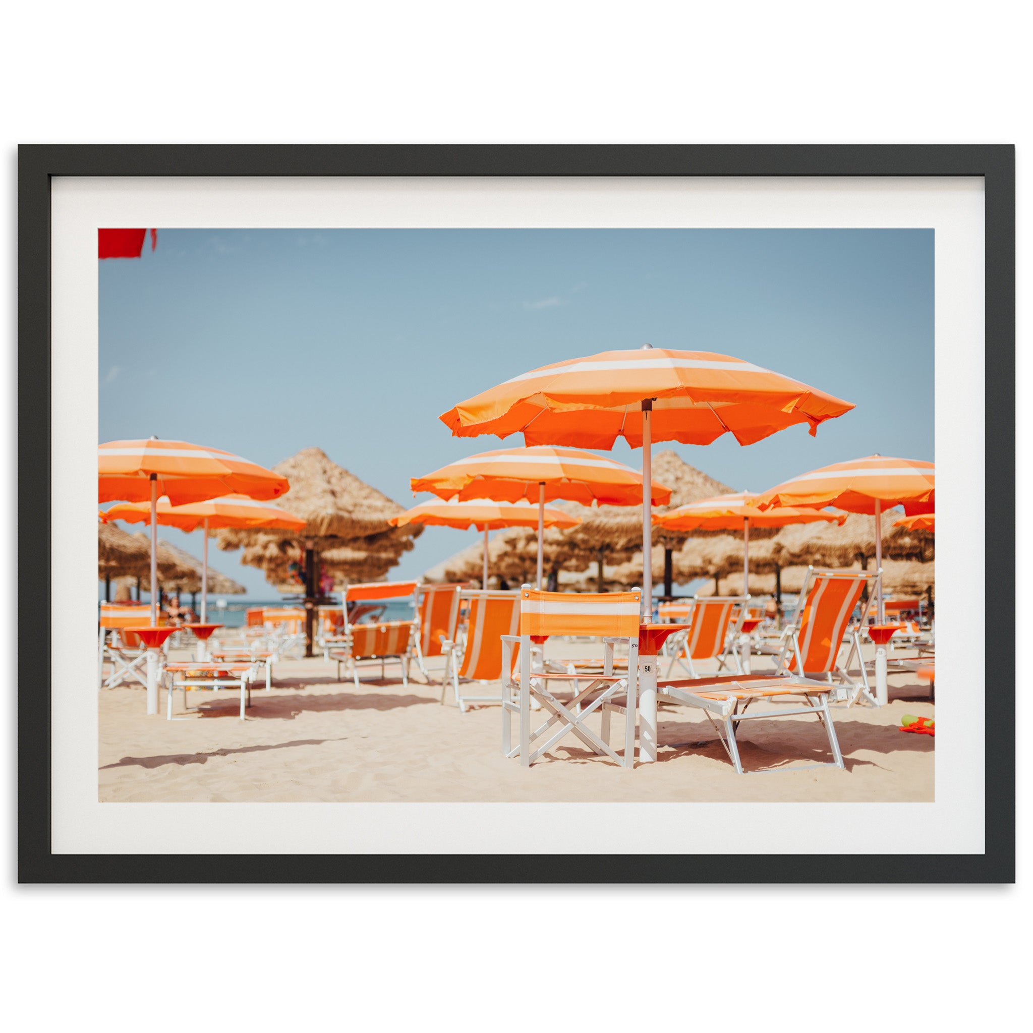 a group of chairs and umbrellas on a beach