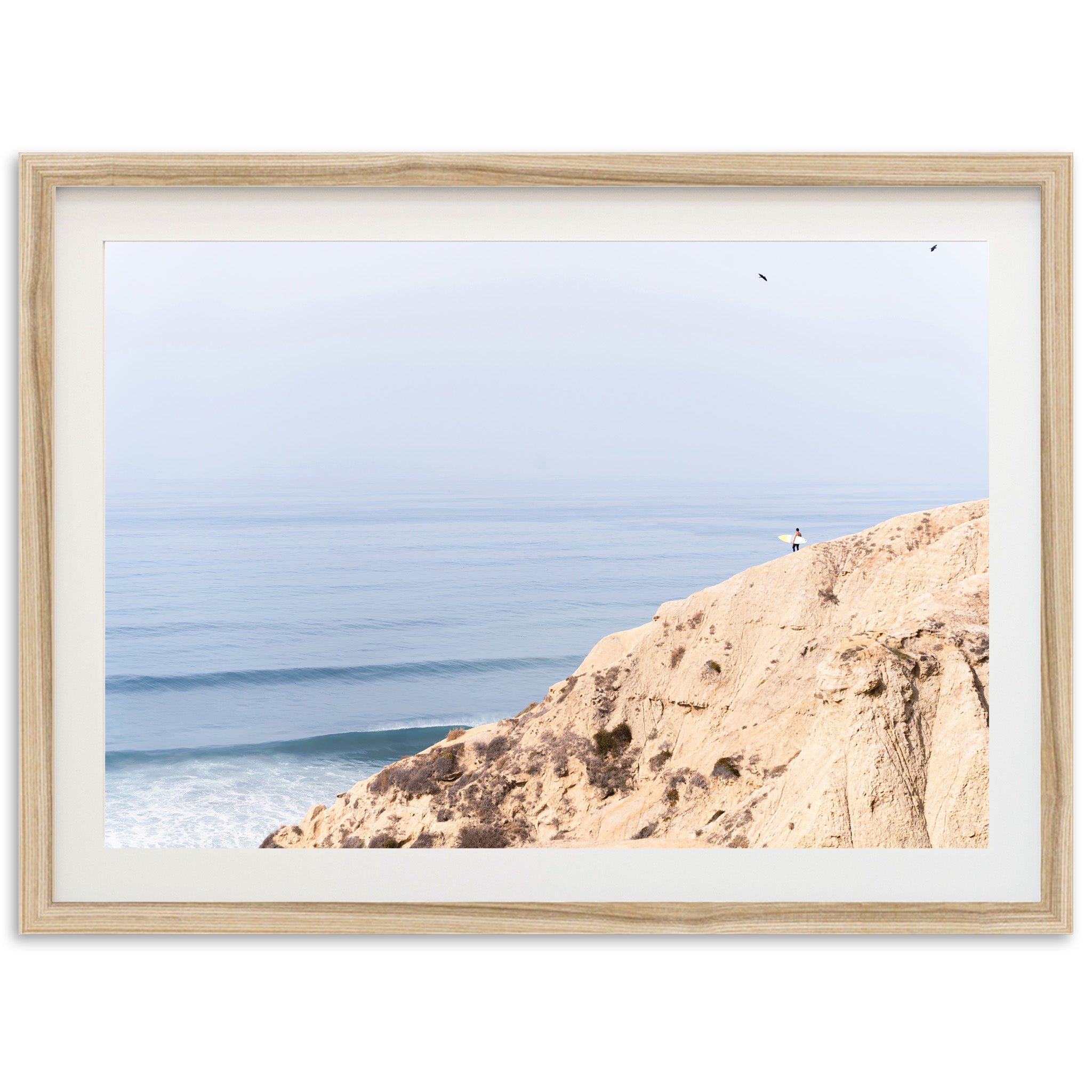 a picture of a person standing on a cliff overlooking the ocean