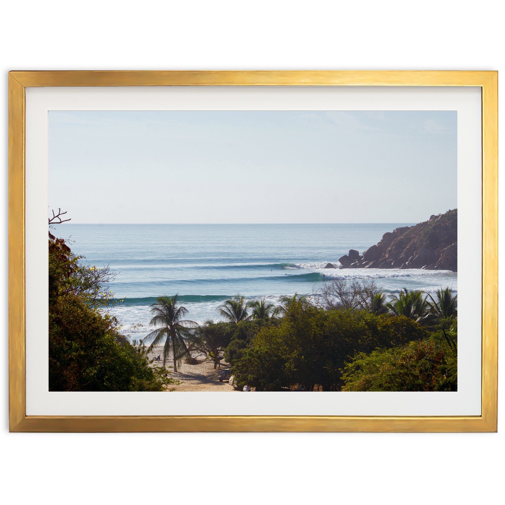 a picture of a beach with a wave coming in