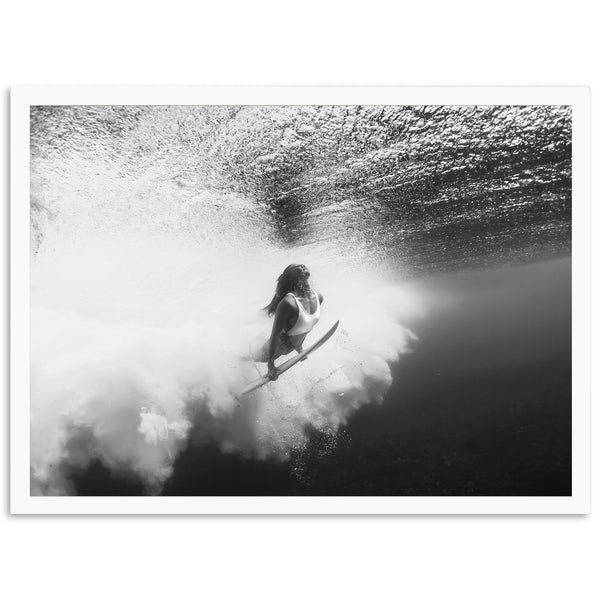 a woman riding a wave on top of a surfboard