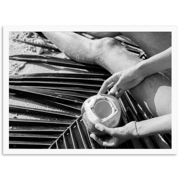 a black and white photo of a person holding a cup