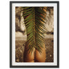 a picture of a woman's butt with a palm leaf