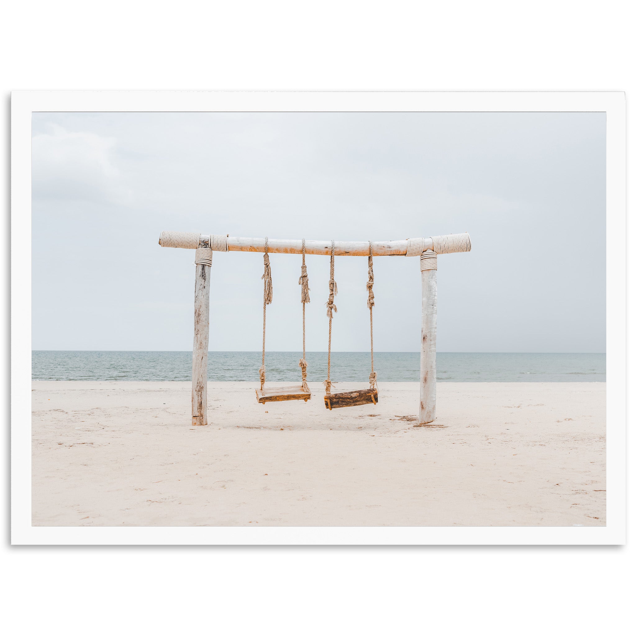 a wooden swing sitting on top of a sandy beach