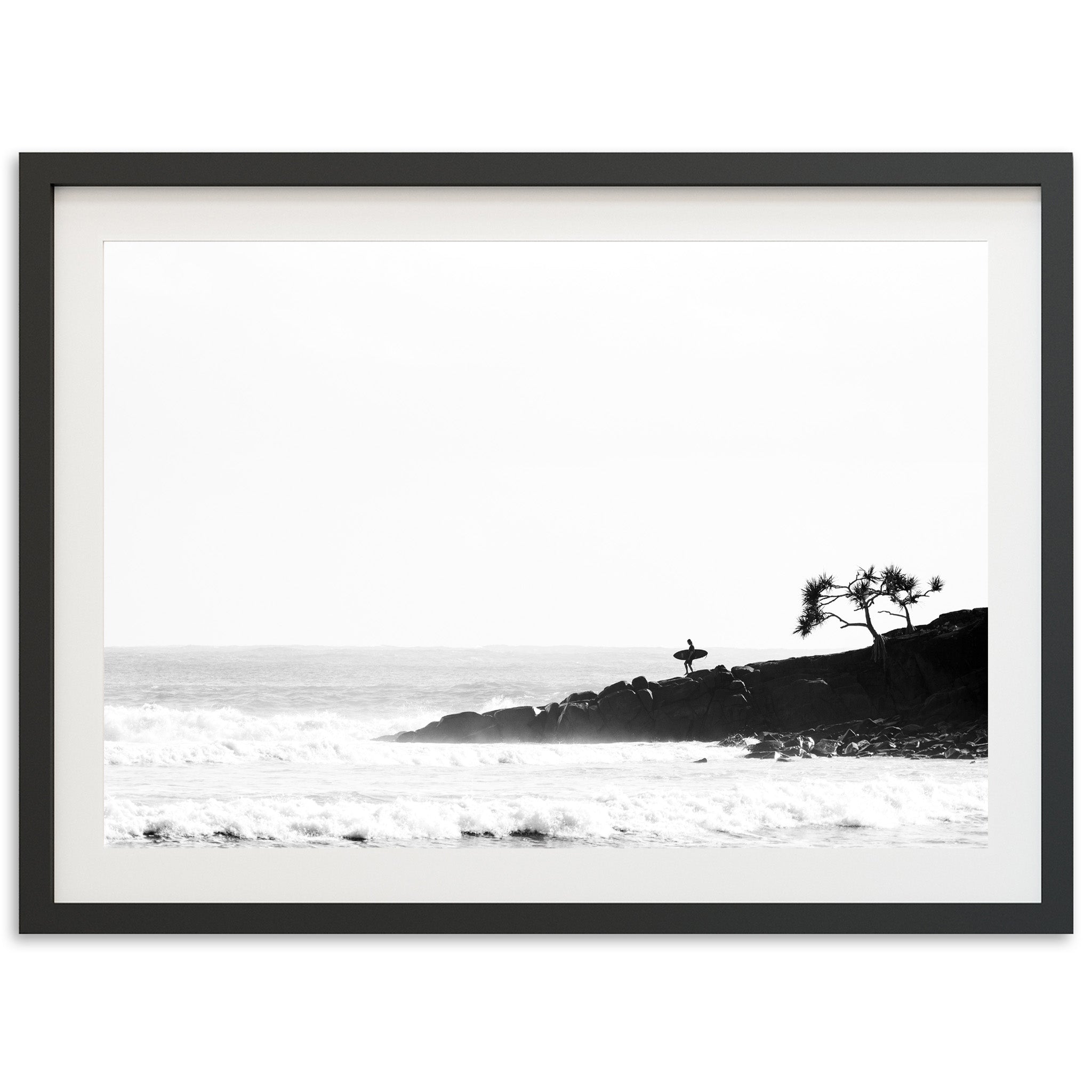 a black and white photo of a beach with waves