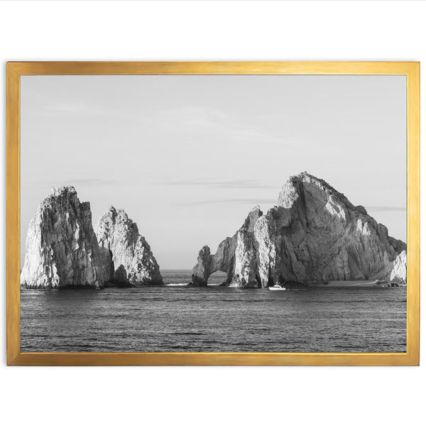 a black and white photo of rocks in the ocean