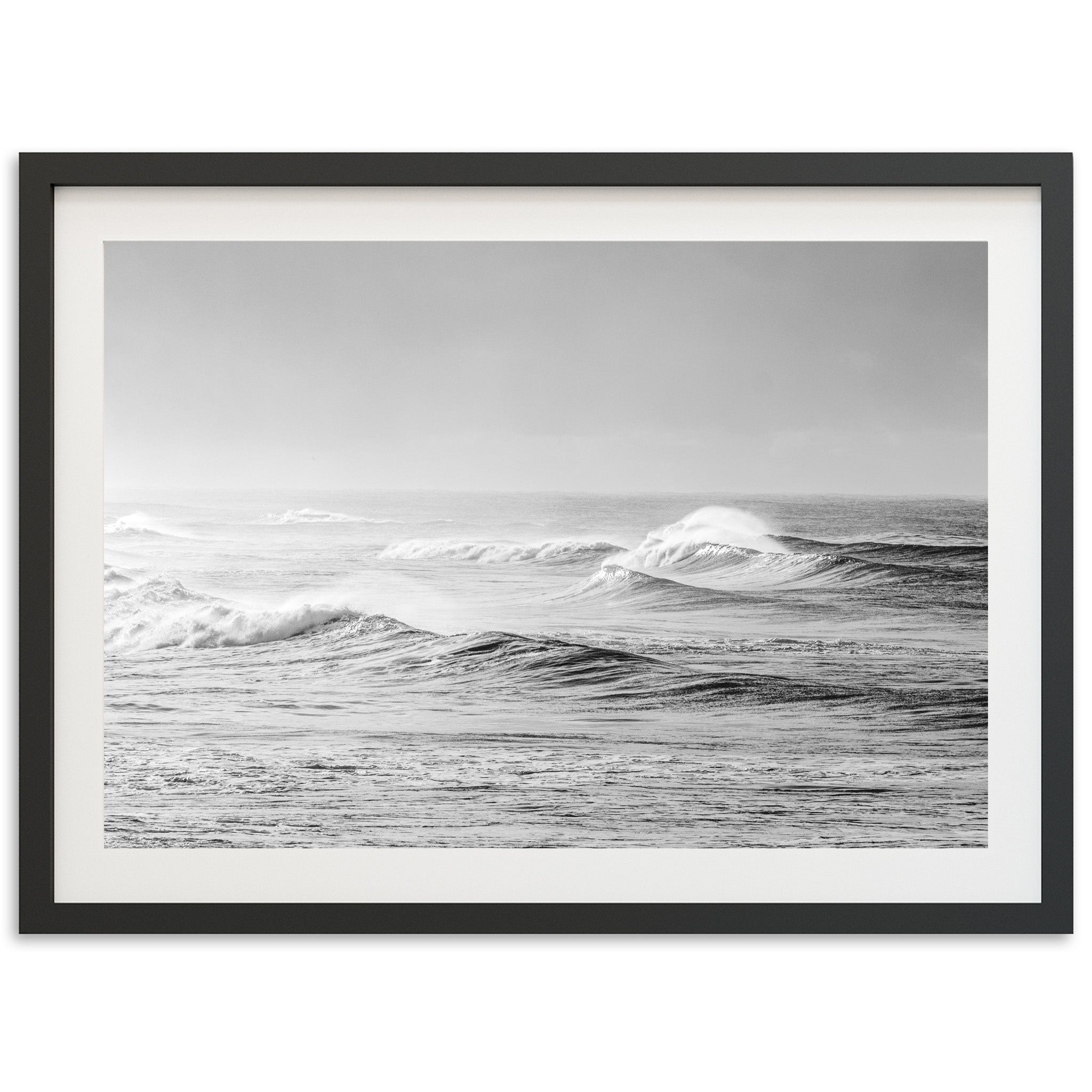 a black and white photo of waves in the ocean