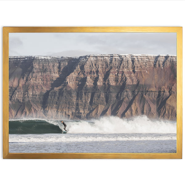 a man riding a wave on top of a surfboard