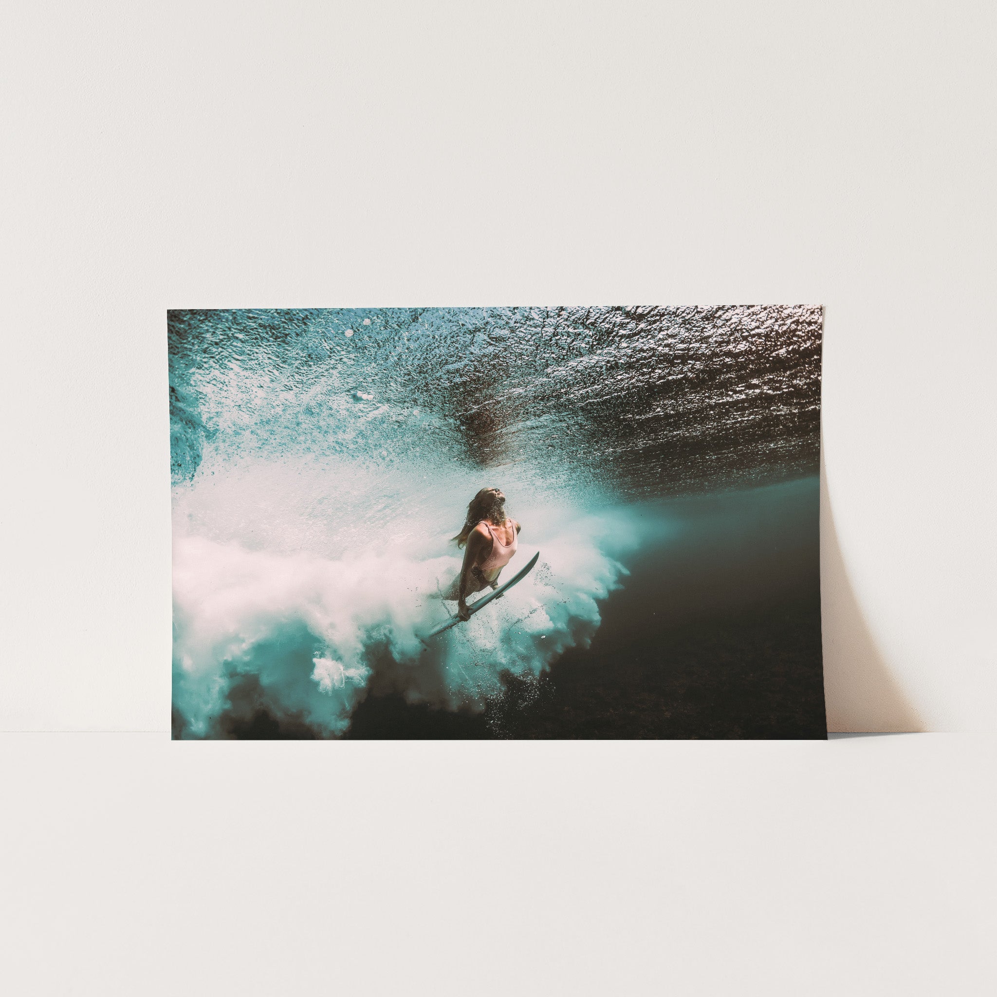 a man riding a wave on top of a surfboard