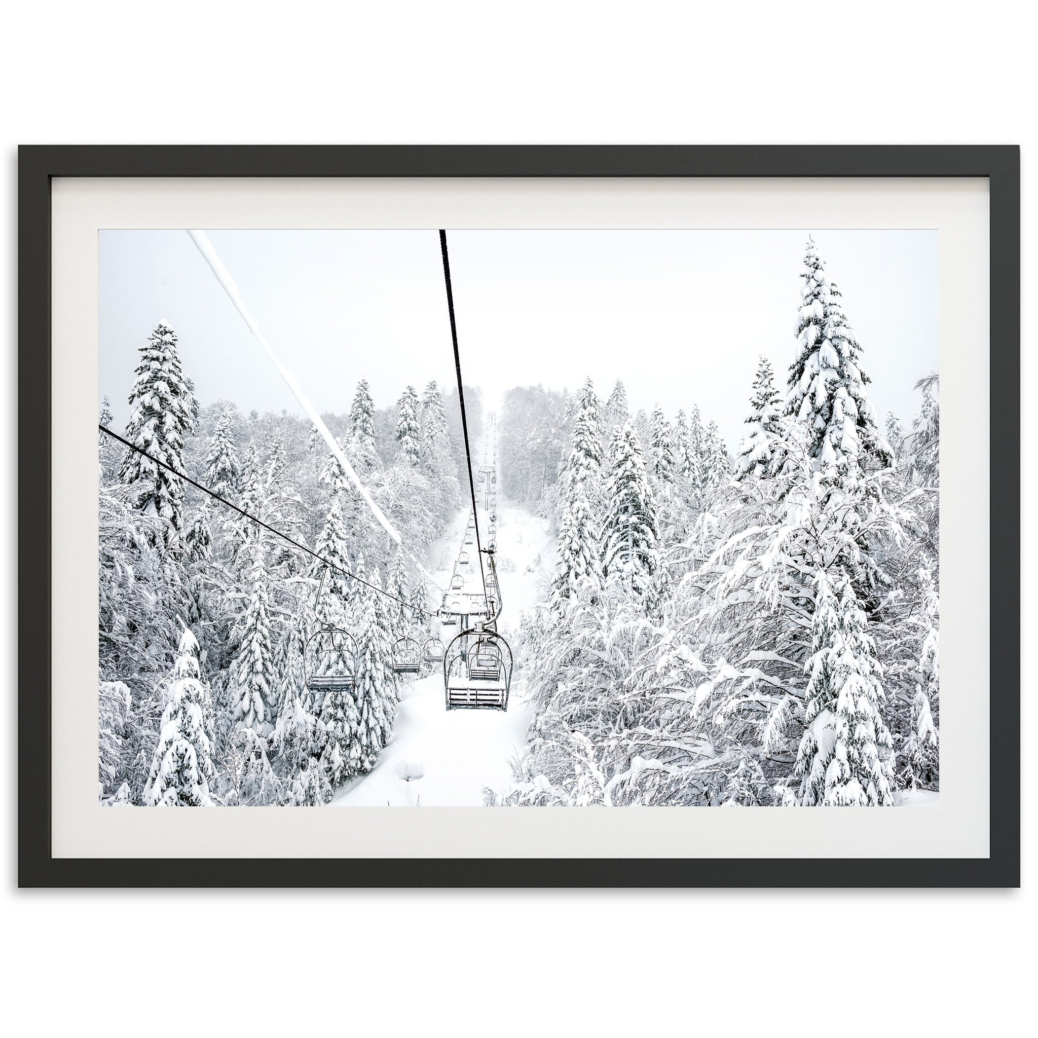 a black and white photo of a ski lift