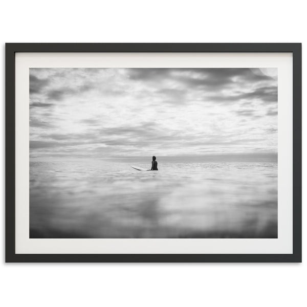 a black and white photo of a person on a surfboard