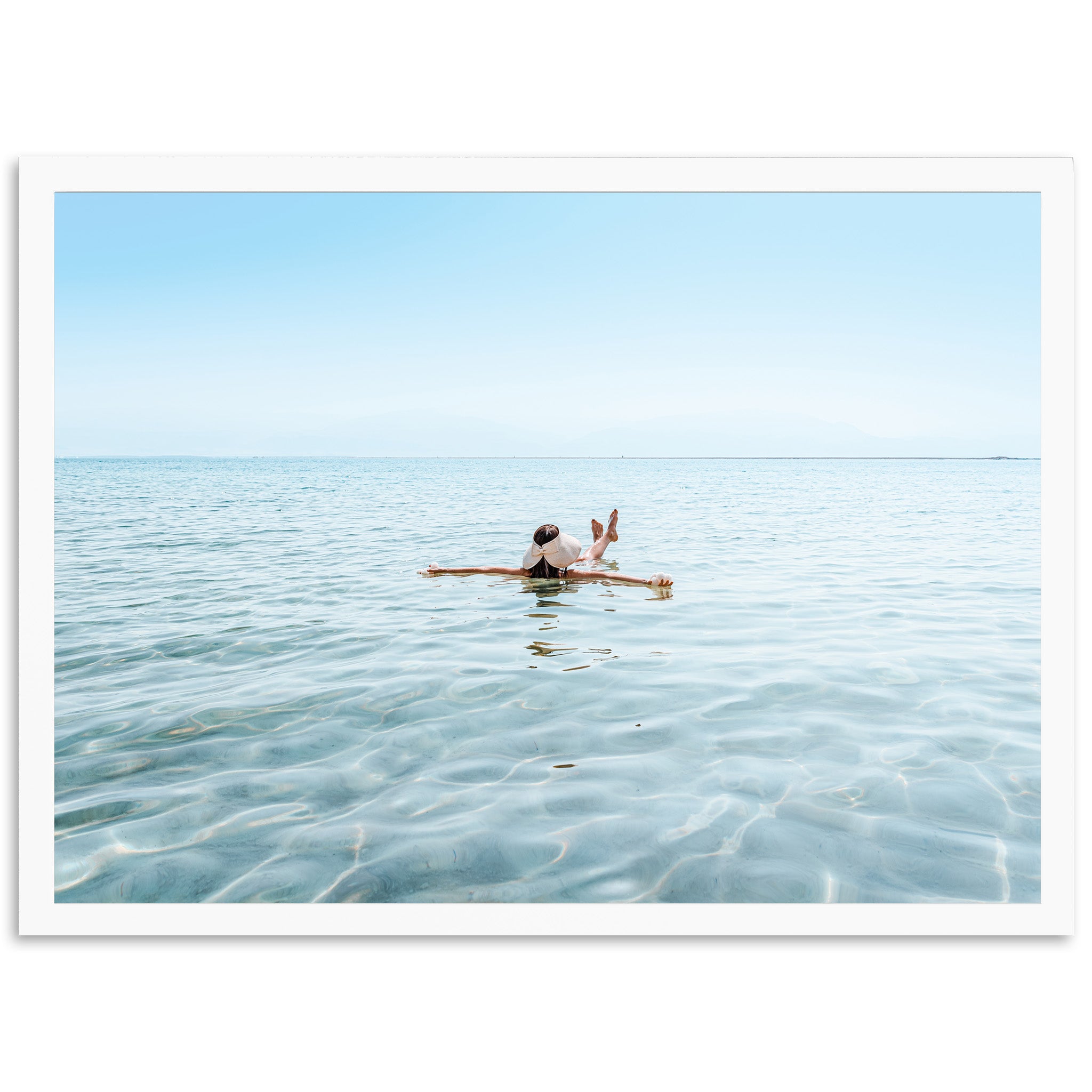 a person sitting on a surfboard in the water