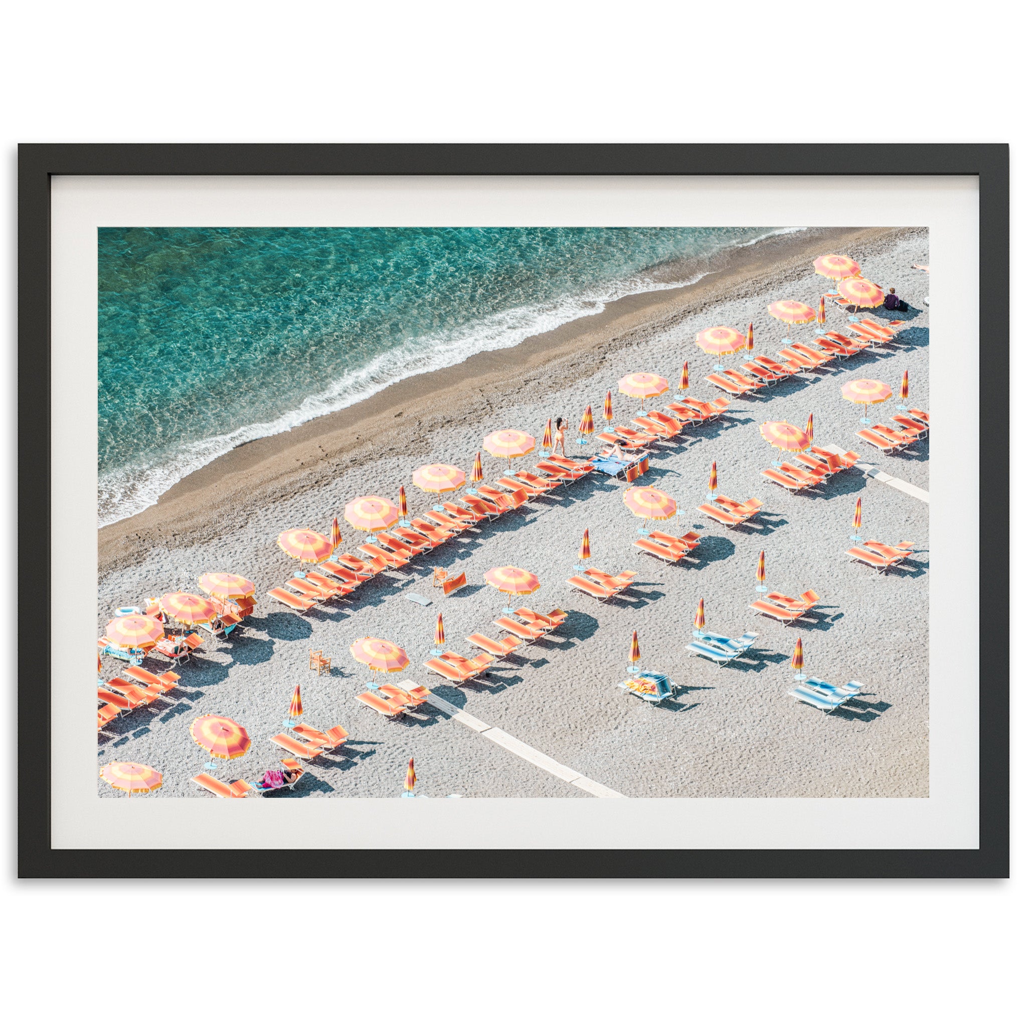 an aerial view of a beach with umbrellas and chairs