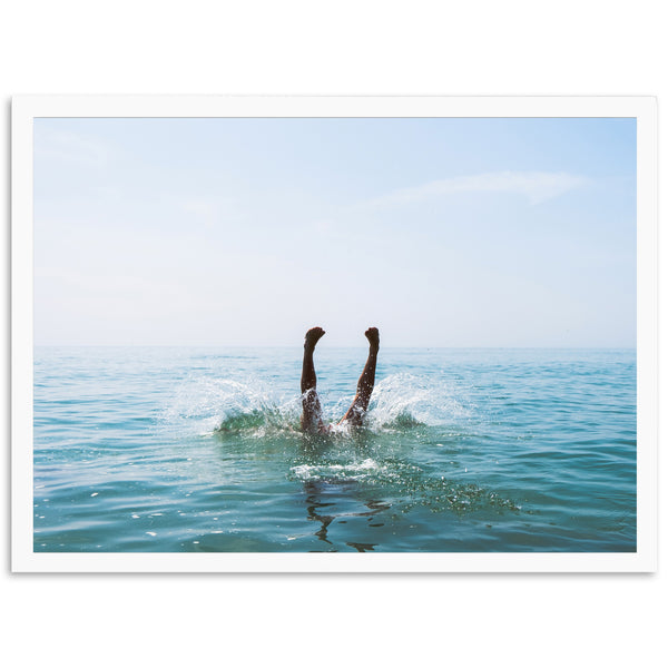 a person swimming in the ocean with their feet in the water