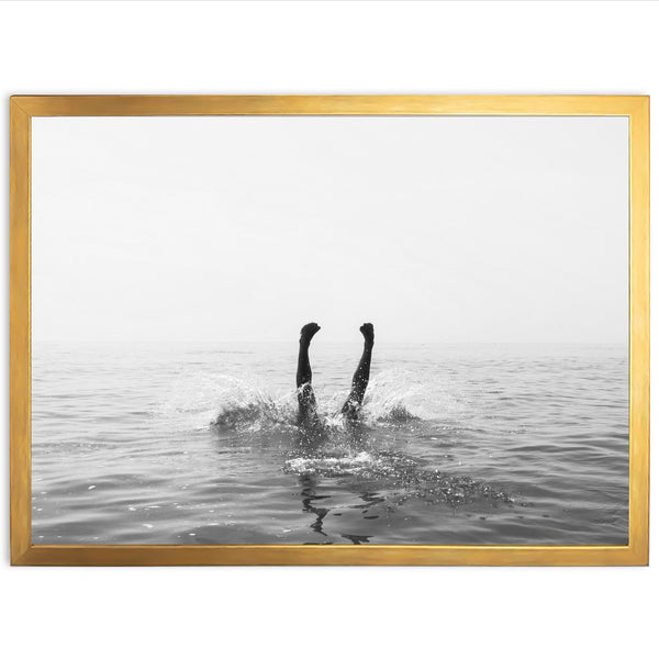 a black and white photo of a person swimming in the ocean