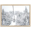 a ski lift in the middle of a snowy forest