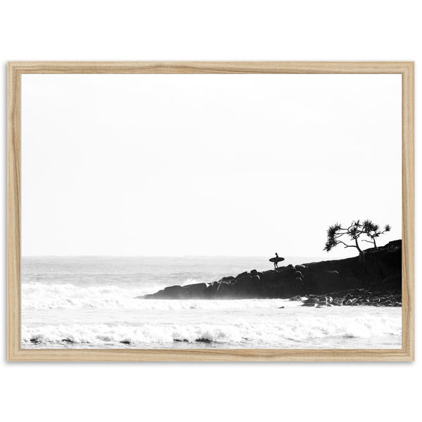 a black and white photo of a beach with a lone tree