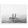 a black and white photo of a person swimming in the ocean