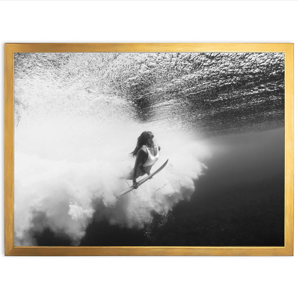 a woman riding a surfboard under a wave in the ocean