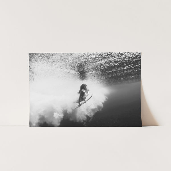 a black and white photo of a person on a surfboard