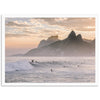 a surfer riding a wave in the ocean with mountains in the background