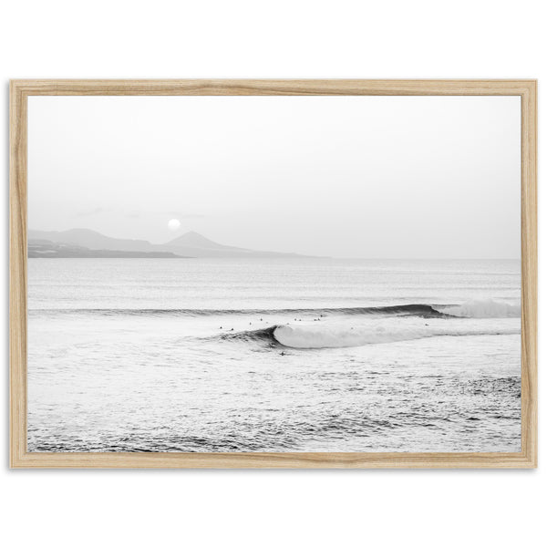 a black and white photo of a surfer in the ocean