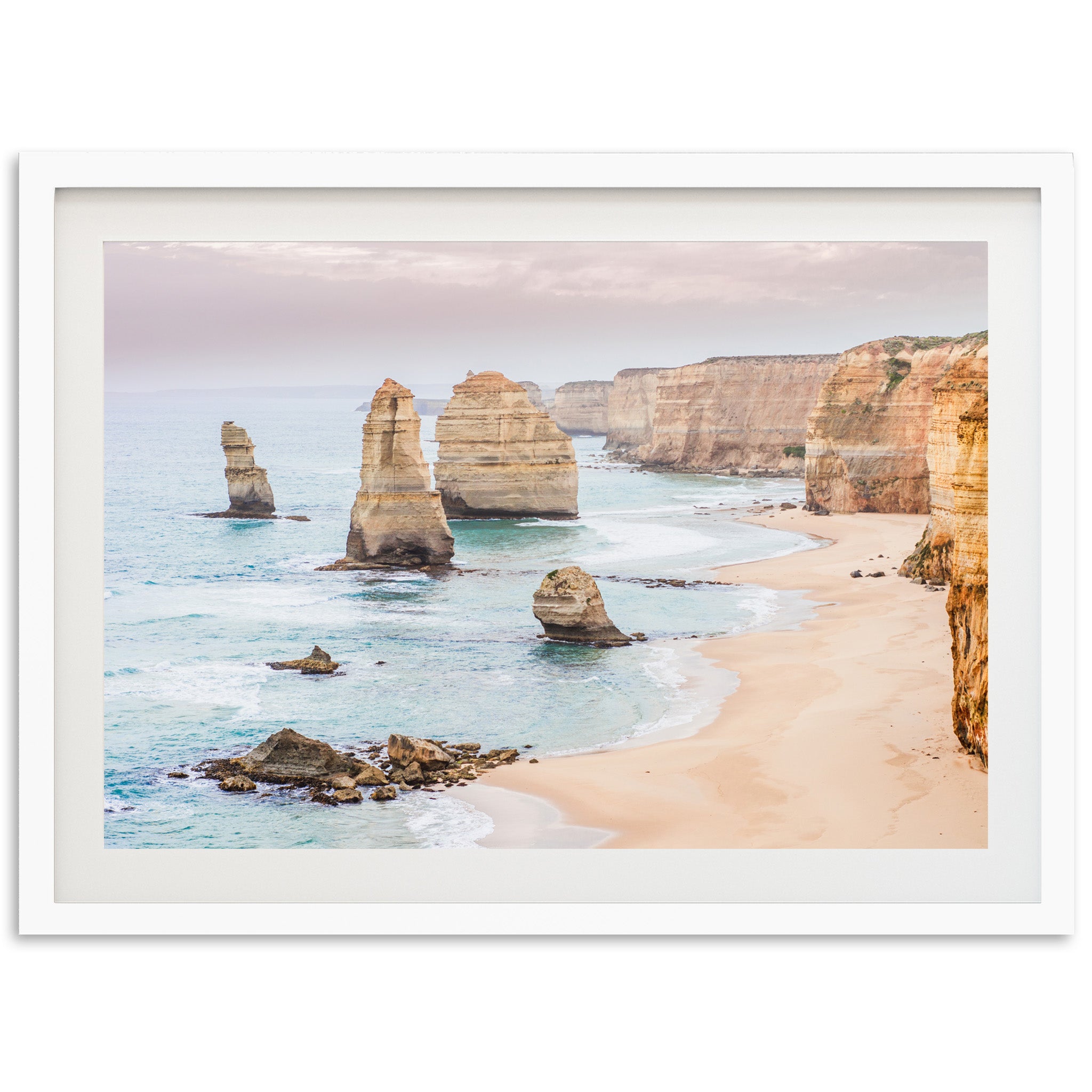 a picture of a beach with some rocks in the water