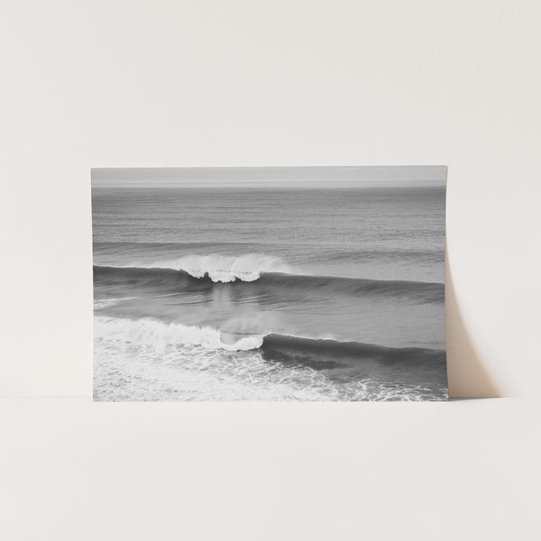 a black and white photo of a wave in the ocean