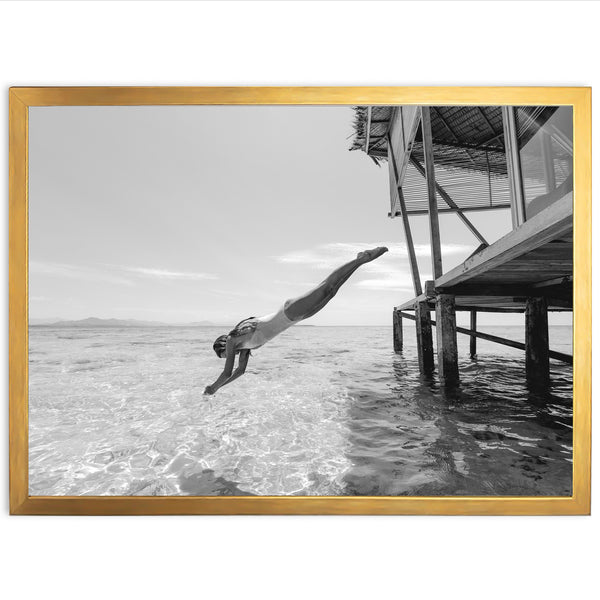 a black and white photo of a person diving into the water