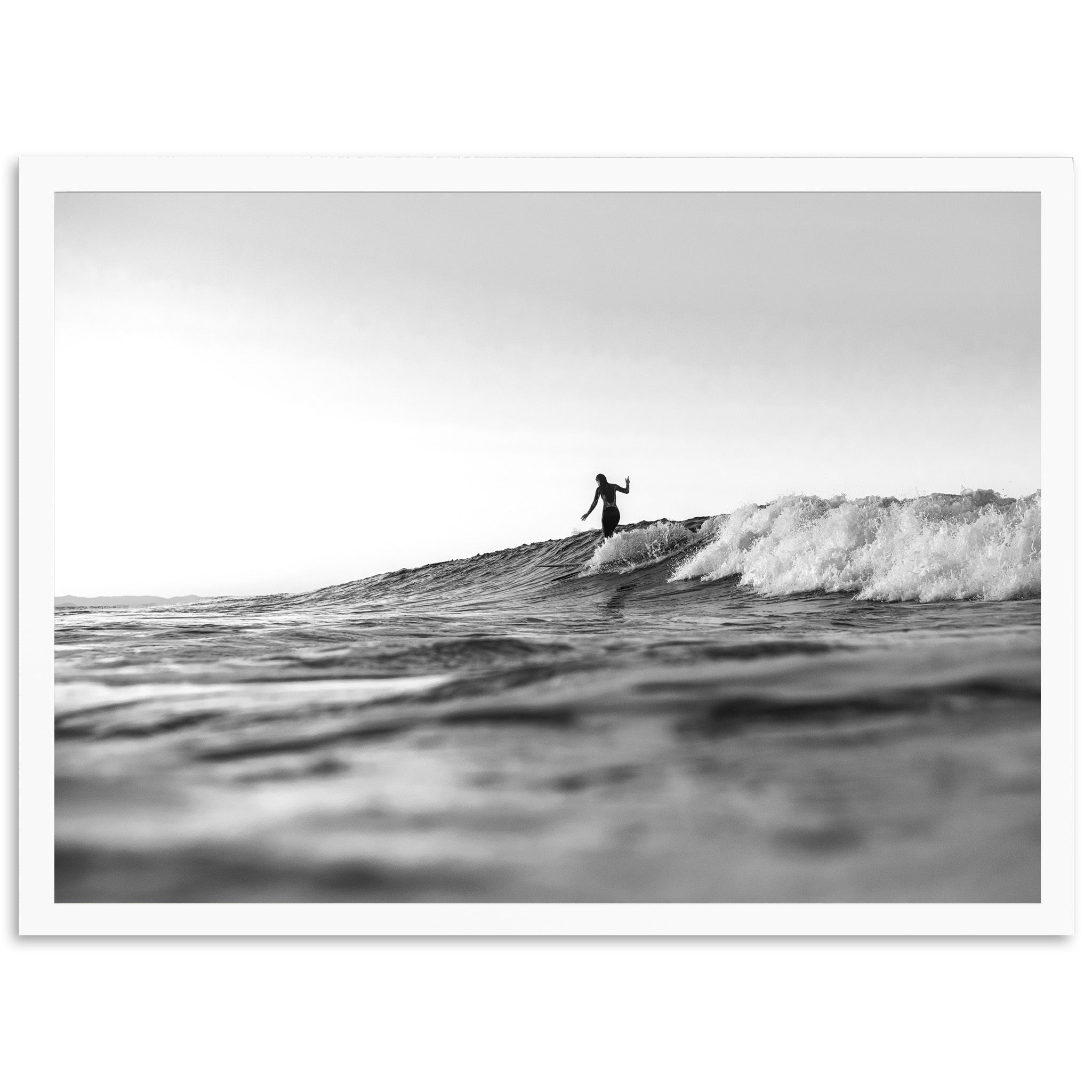 a man riding a wave on top of a surfboard