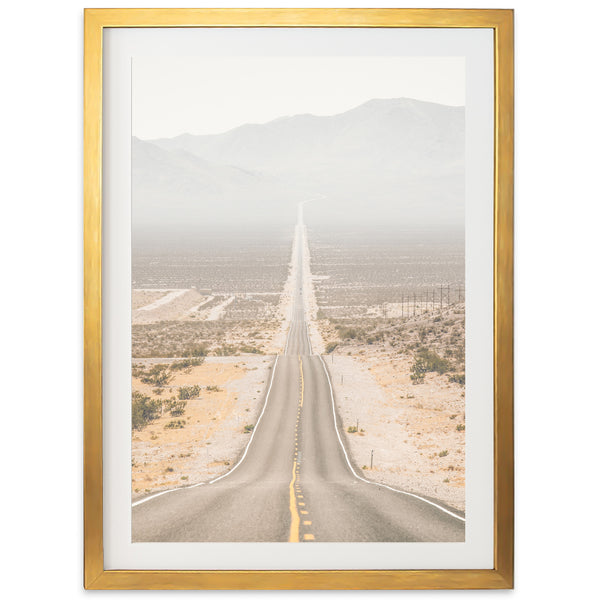 a picture of an empty road with mountains in the background