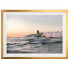 a man riding a wave on top of a surfboard