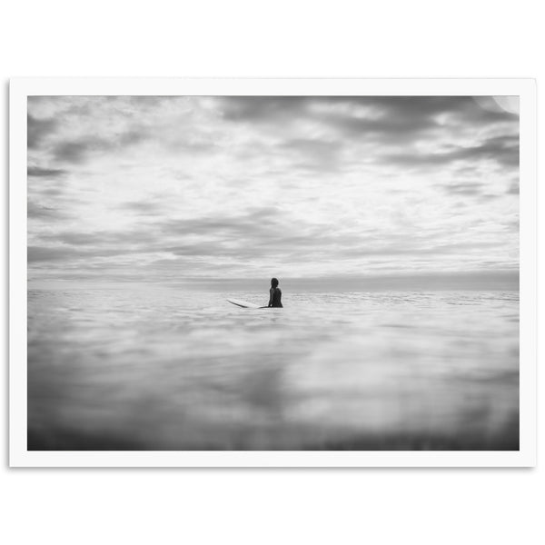 a black and white photo of a person on a surfboard