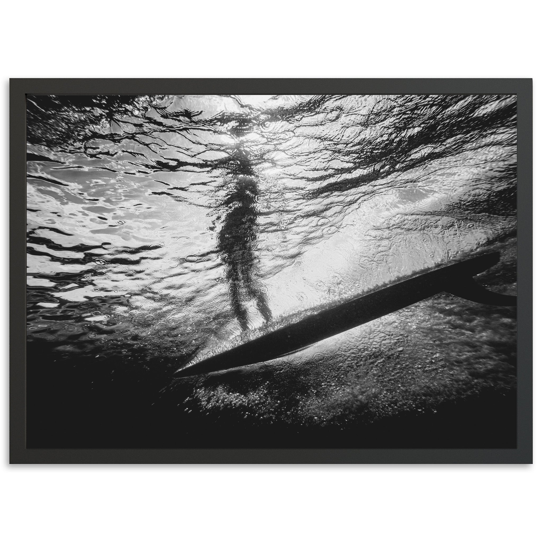 a black and white photo of a person on a surfboard