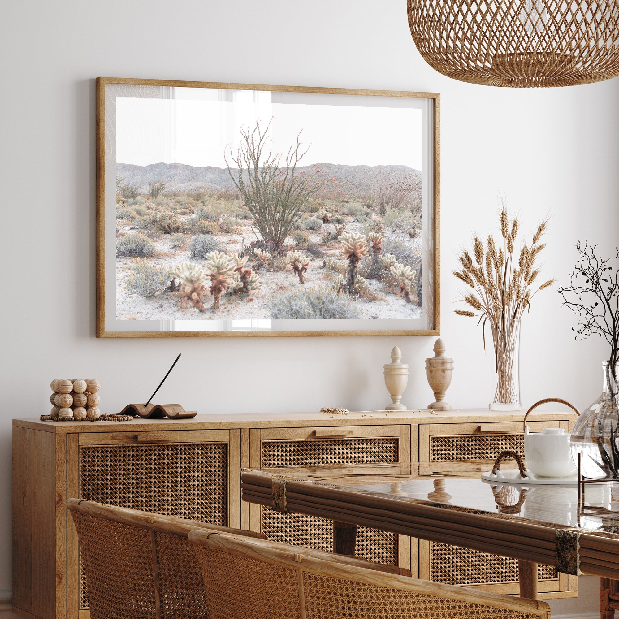 a picture of a desert scene hangs above a dining room table