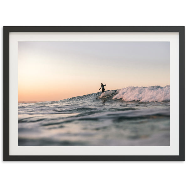 a man riding a wave on top of a surfboard