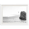 a black and white photo of a rock in the ocean