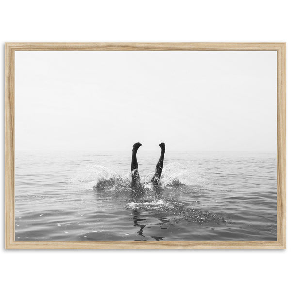 a black and white photo of a person swimming in the ocean