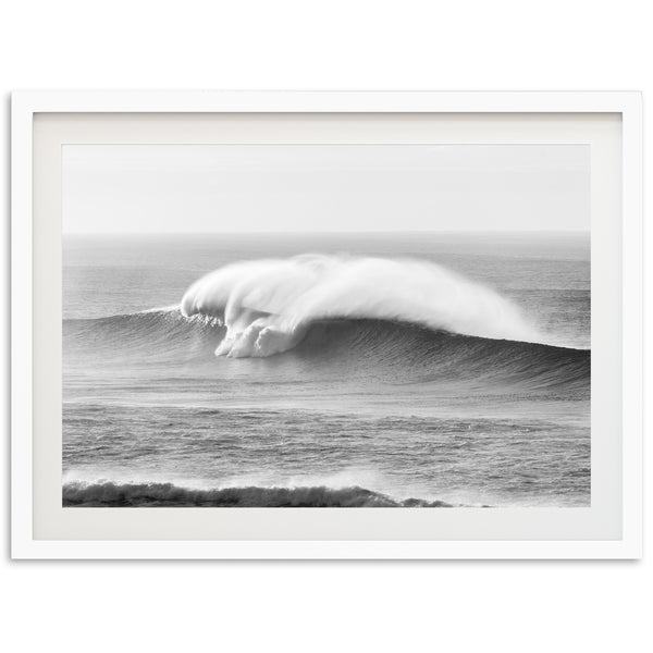 a black and white photo of a large wave