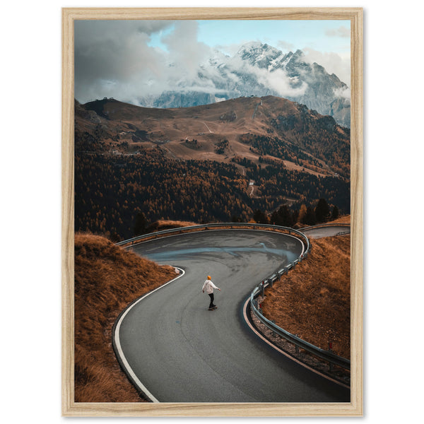 a man riding a skateboard down a curvy road