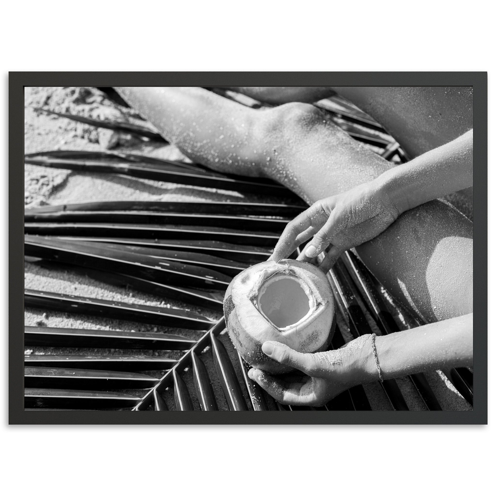 a black and white photo of a person holding a cup