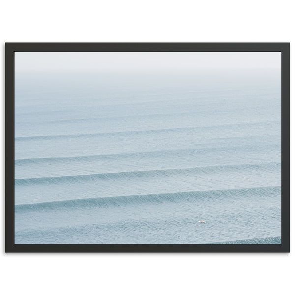 a framed photograph of a wave in the ocean