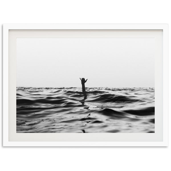 a black and white photo of a person standing on a surfboard